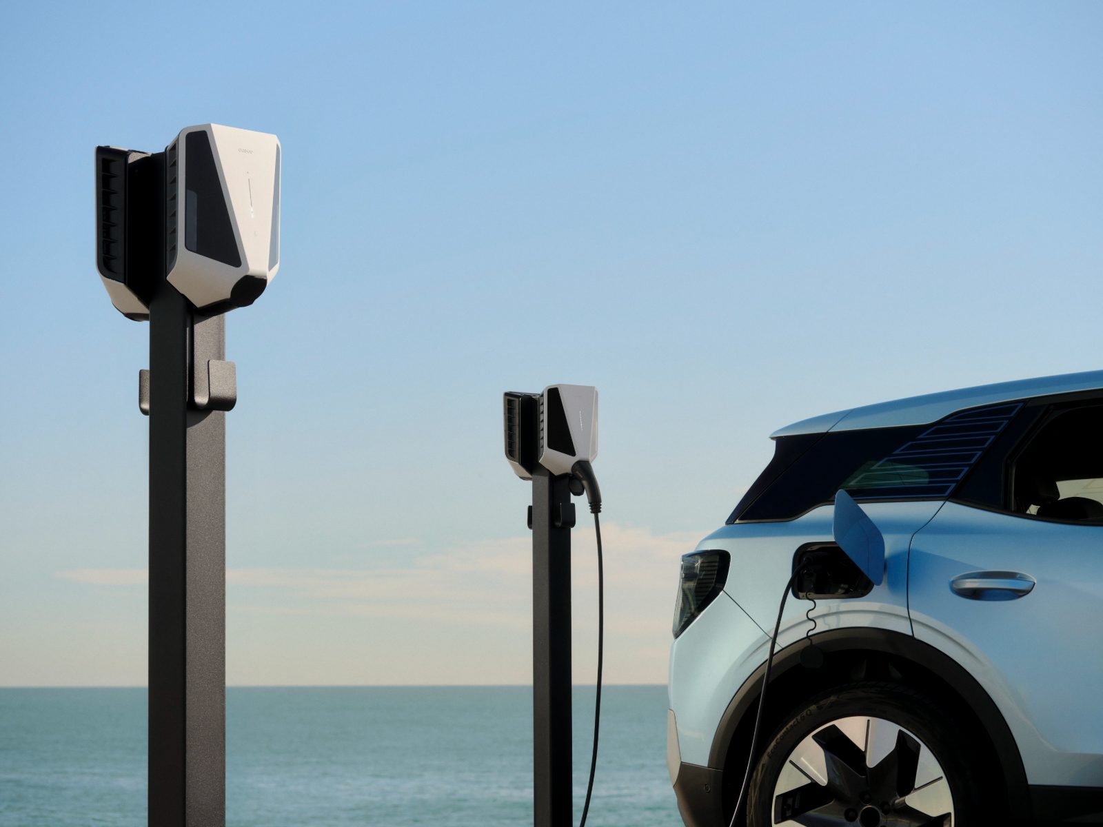 Two pole-mounted Easee chargers, one charging an electric car