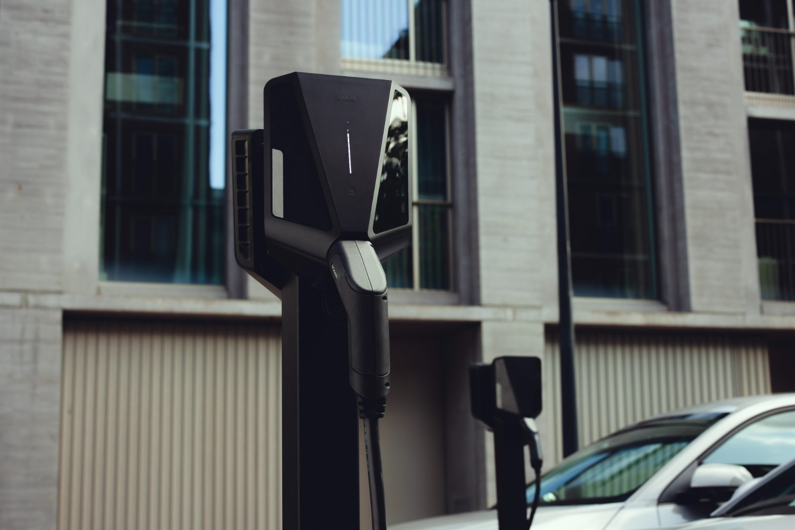 Pole-mounted Easee Pro charger in front of an office building