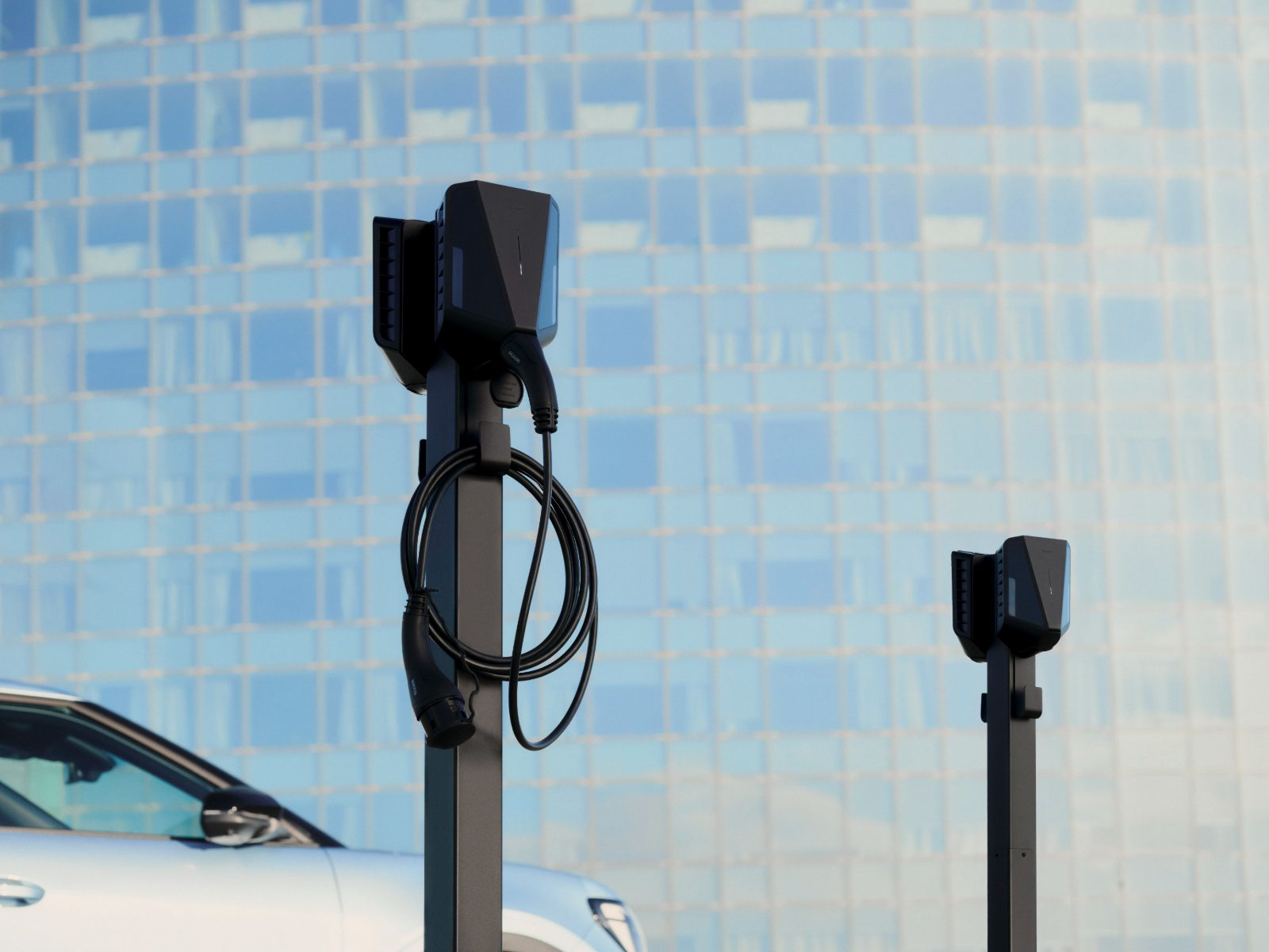 Two pole-mounted Easee Pro chargers installed by MUNEV in an open car park